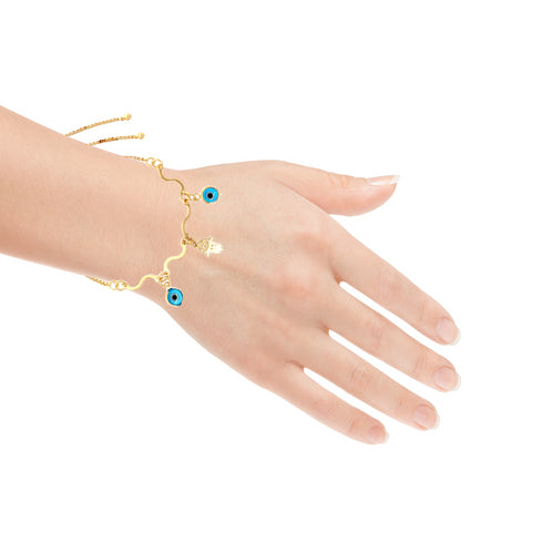 A hand is adorned with the Light Blue Evil Eye and Hamsa Hand Charms Bracelet, showcasing a delicate snake chain link design. Crafted from 14k gold-filled material, the adjustable bracelet features a sleek, minimalist style with blue evil eye and small Hamsa hand charms against a white background.